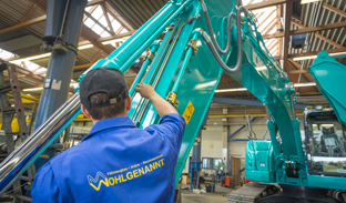 person cleaning excavator
