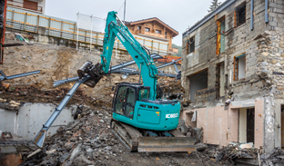 excavator removing concrete